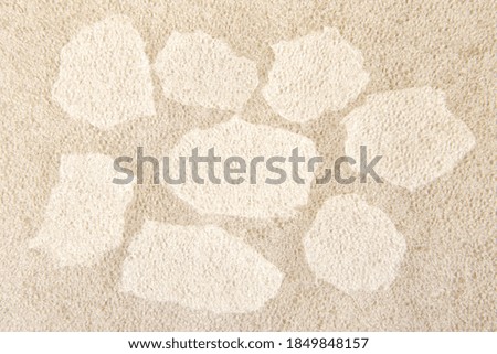 White plastic foam sheet pieces on cardboard background. Closeup of torn foam polyethylene pieces.
