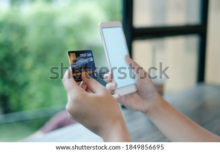 Mockup smart phone image. White screen. Women holding credit card and using mobile phone. Online shopping concept.