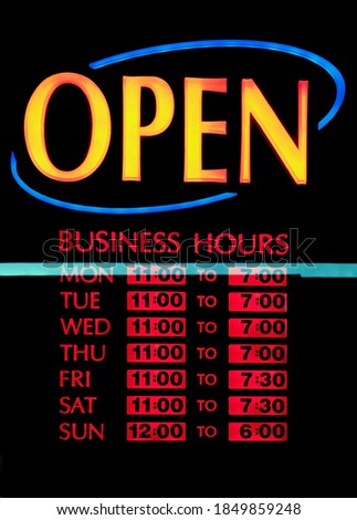 Back lit OPEN business days and hours sign.