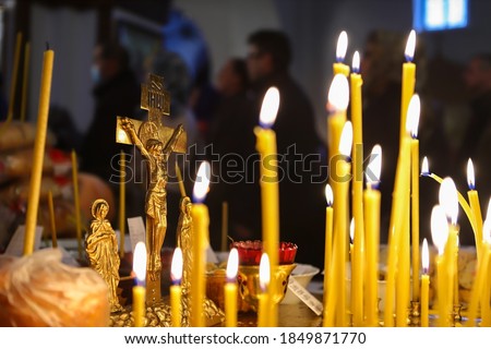 Funeral liturgy with prayer for the dead. Crucifixion, bread and candles in the Orthodox Church. The concept of Orthodoxy. Royalty-Free Stock Photo #1849871770