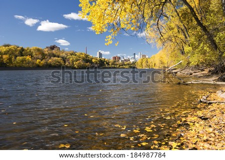 Autumn colors along the Mississippi River, Minneapolis skyline in the distance. Minnesota