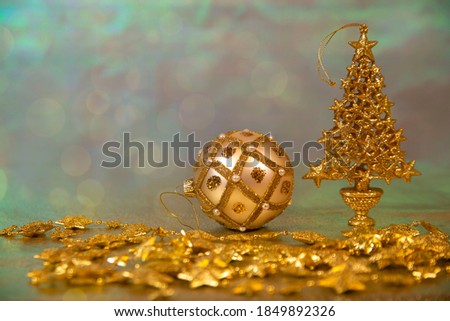 Christmas glittering gold decorations on an iridescent background, with copy space. Celebrating Christmas and New Year. 
