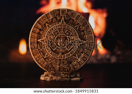 Mexican national emblem made of clay, mystical scene by candlelight that shows the union of the physical and spiritual worlds through unique symbols of the Aztec culture of pre-Hispanic times