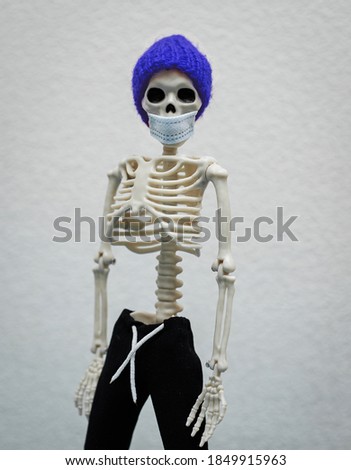 The skeleton is wearing a mask. Protection against Coronavirus COVID-19. Pandemic.