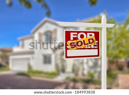 Sold Home For Sale Real Estate Sign in Front of Beautiful New House.