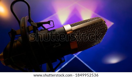 Microphone with pedestal in party atmosphere with background of lights and color