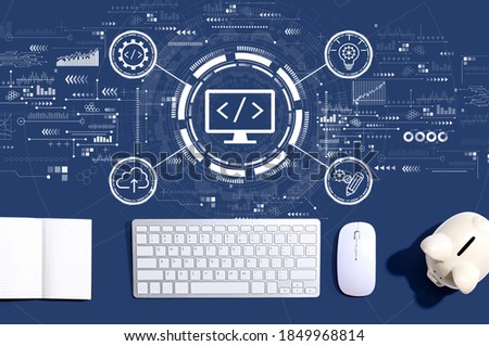 Web development concept with a computer keyboard and a piggy bank
