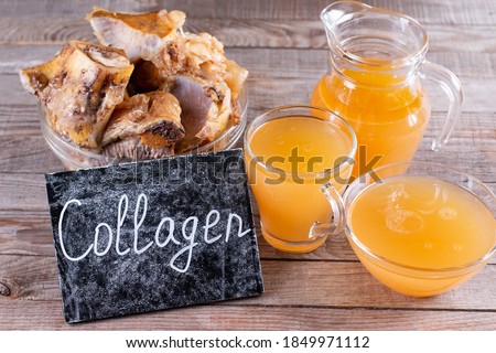 Homemade beef bone broth with natural collagen. Bouillon in a glass mug. Selective focus Royalty-Free Stock Photo #1849971112