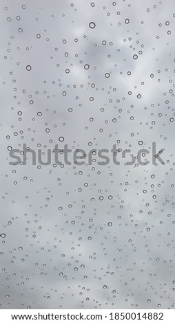 Close up of water drops on clean bright window focused detail