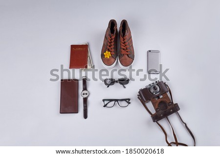Mix of vintage and modern stuff top view. Retro photo camera and smartphone. Isolated on white background.