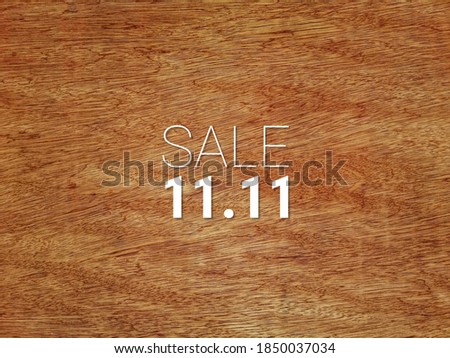 Sale 11.11 or sale on 11 November wording on dark brown wood surface. 
