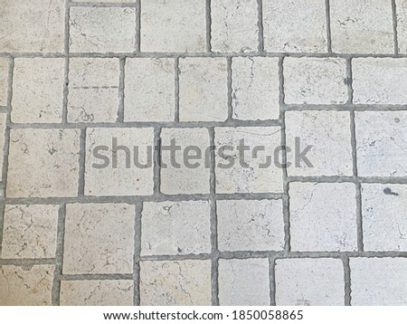 The texture of the stone floor, large stones, paving stones. Covering the road in the old town