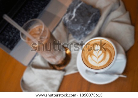 Hot coffee and iced coffee on wooden table, stock photo