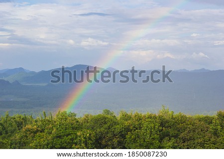 rainbow while raining fall mountain and nature background