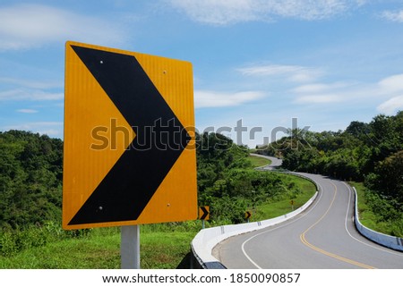 Curve road sign, traffic signal turn right on the number three curve road along the mountain at Nan Province, North of Thailand. 