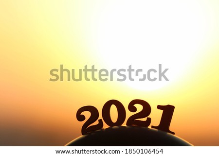New Year 2021. The word 2021 behind the mountain at golden sunset and beautiful sky.