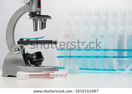 Microscope for analyzes covid-19 sample and vaccine on laboratory background. Backstage of scientific discovery. Healthcare and medicine concept.