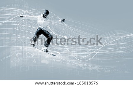 Male snowboarder making jump against media background