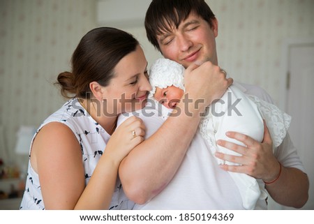 parents with a newborn in their arms. a man and a woman with a long-awaited child. happy family.
