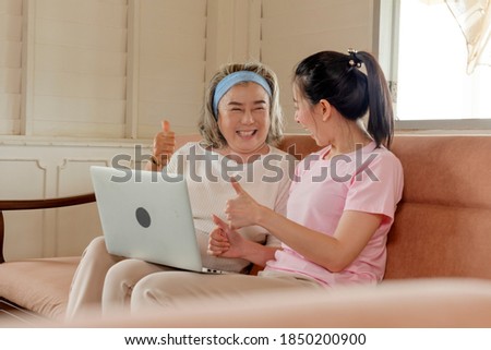 Mother and daughter use notebooks to communicate with father who is abroad. They have smiling faces. Who met through video calls To relieve nostalgia. Happy family concept Royalty-Free Stock Photo #1850200900