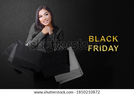 Asian woman carrying a shopping bag with Black Friday text with a colored background. Black Friday concept