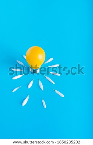 Yellow light bulb on a blue background.symbol of idea 