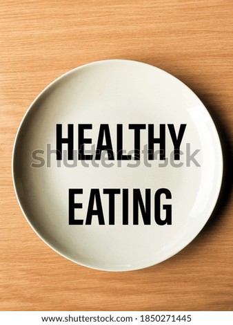 'Healthy Eating' on a Plain White Plate with Woody Background 