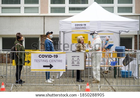 People waiting in covid-19 testing center outdoors on street, coronavirus concept. Royalty-Free Stock Photo #1850288905