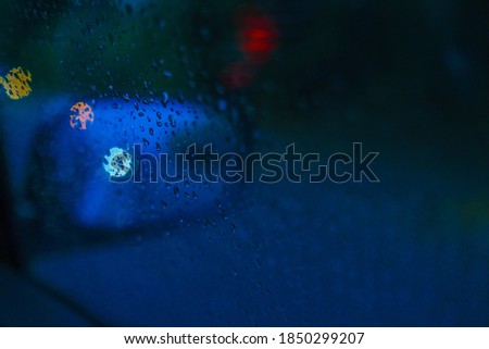 Abstract blue hour raining on the car wind screen
