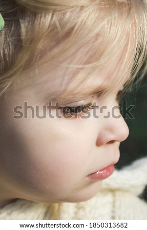 Close up portrait of cute three years old blonde girl.