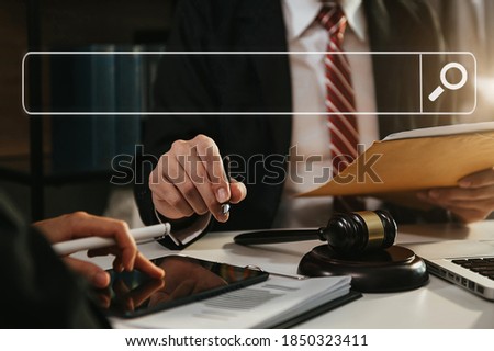 
Searching Browsing Internet Data Information Networking Concept with blank search bar.justice and law concept.Male judge in a courtroom with the gavel,working with digital tablet 

