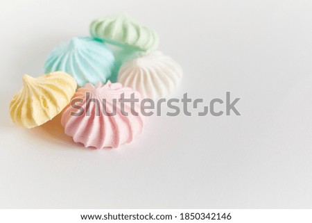 Pastel colored meringue on white background