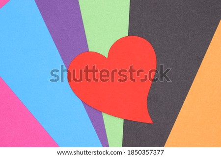 red paper heart on colorful background