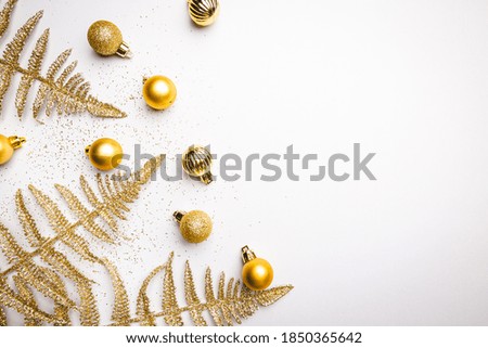 Christmas holidays composition with gold decorations on white background with copy space for your text