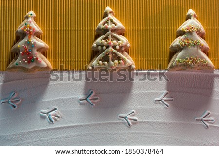 Image of Christmas cookies made in the form of Christmas trees and bird footprints