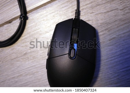 Black computer mouse on the desktop. 