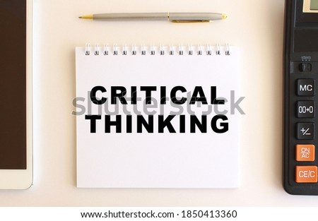 Notepad with text CRITICAL THINKING on a white background. Business concept.