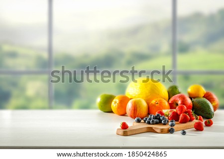 Fresh fruit in the kitchen on a wooden table by the sunny window Royalty-Free Stock Photo #1850424865