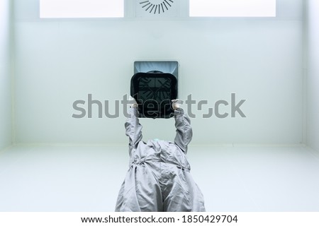 The unidentified operator is using the capture hood balometer to measuring the air velocity and volume of supply air from HVAC system in the clean room. Royalty-Free Stock Photo #1850429704