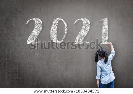 2021 Happy new year school class academic calendar with student kid's hand drawing greeting on teacher's black chalkboard for back to school educational celebration, classroom schedule concept 