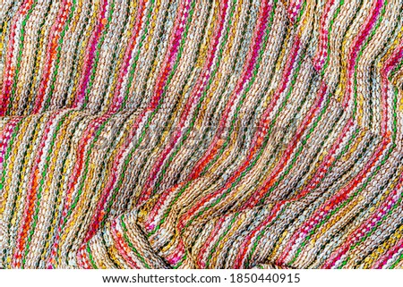 Abstract multicolor cloth texture, closeup fashion background. Multicolored plaid tweed fabric. Fashionable knitted fabric backdrop, copy space, text place