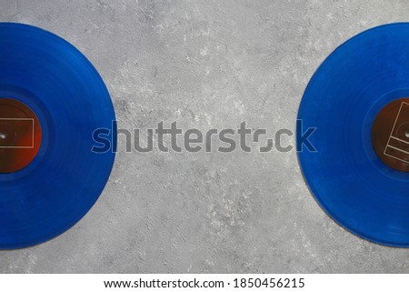 Blue Vinyl record on a stone background. Retro style. Top view.