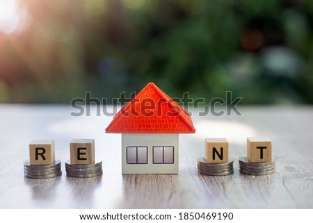 Orange houses and small houses on the coin pile Real estate concepts, mortgages, home loans, future homes and home rentals.
