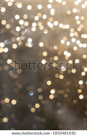 Bokeh of raindrops on the window on a Sunny day. Holiday. Blurry background. Defocus.