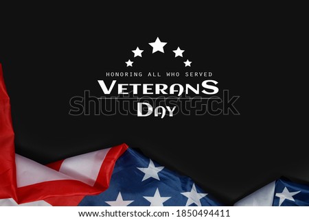 Happy Veterans Day. American flags with the text thank you veterans against a black background. November 11.