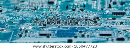 The concept of nanotechnology and the Internet. An electronic plateau with conacts and microchips of blue color with a soft focus in a low key. Royalty-Free Stock Photo #1850497723