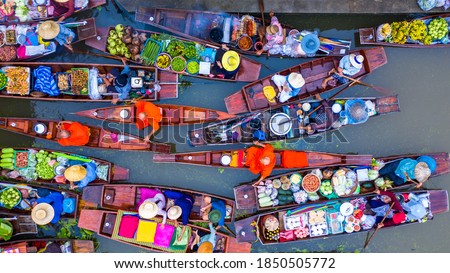 Aerial view famous floating market in Thailand, Damnoen Saduak floating market, Farmer go to sell organic products, fruits, vegetables and Thai cuisine, Tourists visiting by boat, Ratchaburi, Thailand Royalty-Free Stock Photo #1850505772