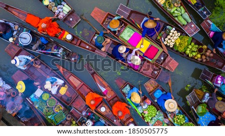 Aerial view famous floating market in Thailand, Damnoen Saduak floating market, Farmer go to sell organic products, fruits, vegetables and Thai cuisine, Tourists visiting by boat, Ratchaburi, Thailand Royalty-Free Stock Photo #1850505775