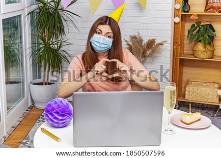 Woman celebrating her birthday at home and communicate with friends or family by video chat because of the covid19 pandemic.