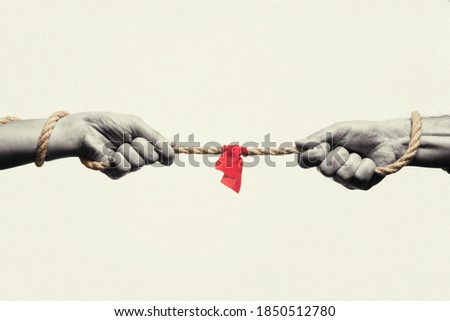 A man and a woman are tug of war. Concept. Black and white. Royalty-Free Stock Photo #1850512780